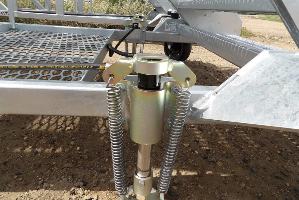 Hydraulic stabilizer with dual spring tensioners attached to metal platform frame.