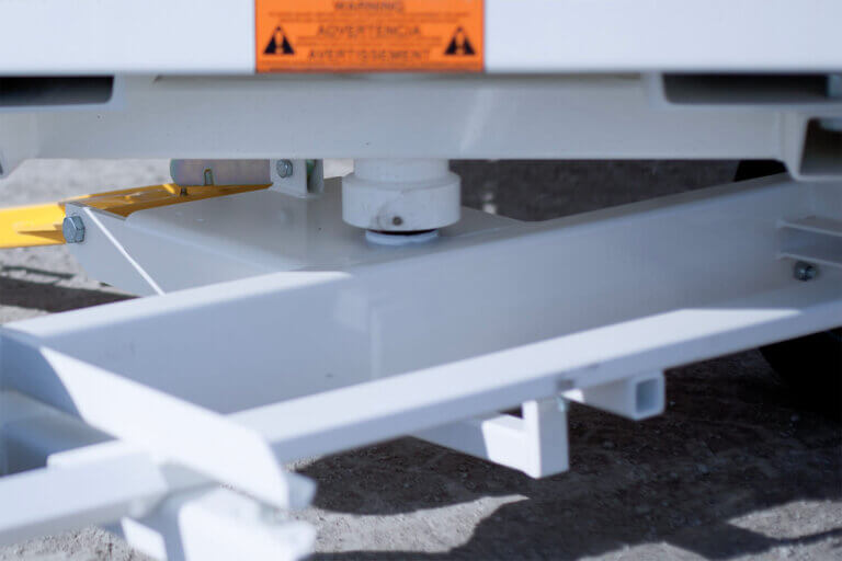 Close-up of white powder-coated ground support equipment showing full wheel rotation capabilities.