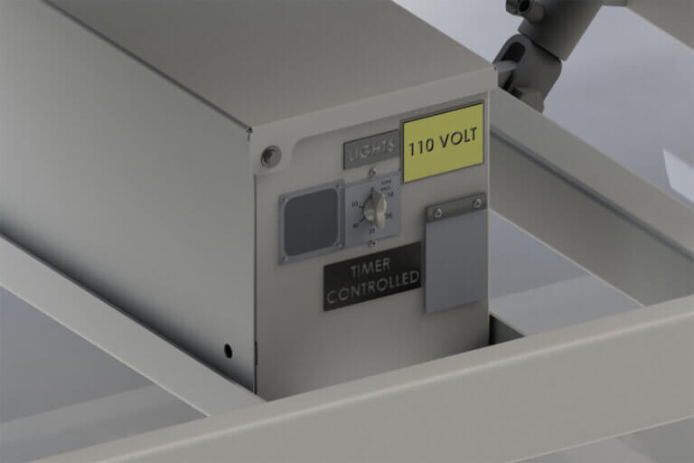 Industrial lighting control panel with 110 volt warning, timer dial, and "Timer Controlled" label mounted on white metal frame.