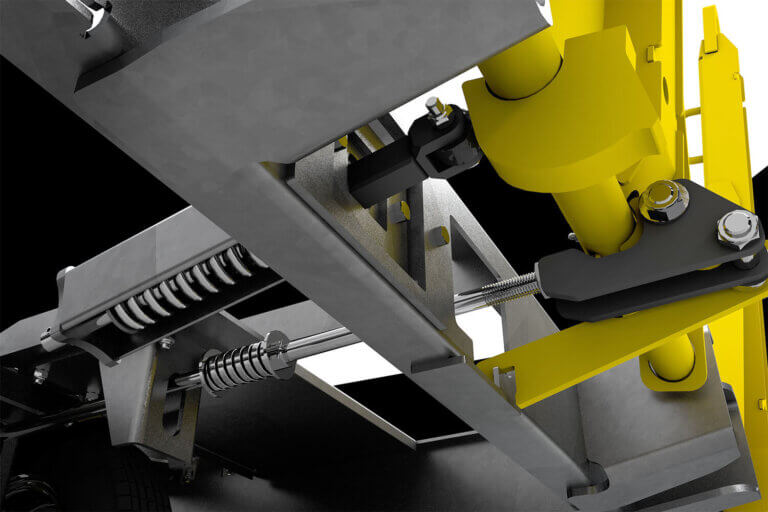 Close-up view of industrial towbar mechanism with yellow hydraulic components and gray metal framework with spring-loaded assembly.