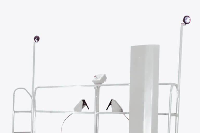 White scissor lift safety railing with mounted work lights and control panel against neutral background.