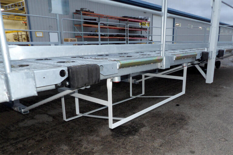 Sort platform with rubber bumpers and metal framework outside warehouse facility.